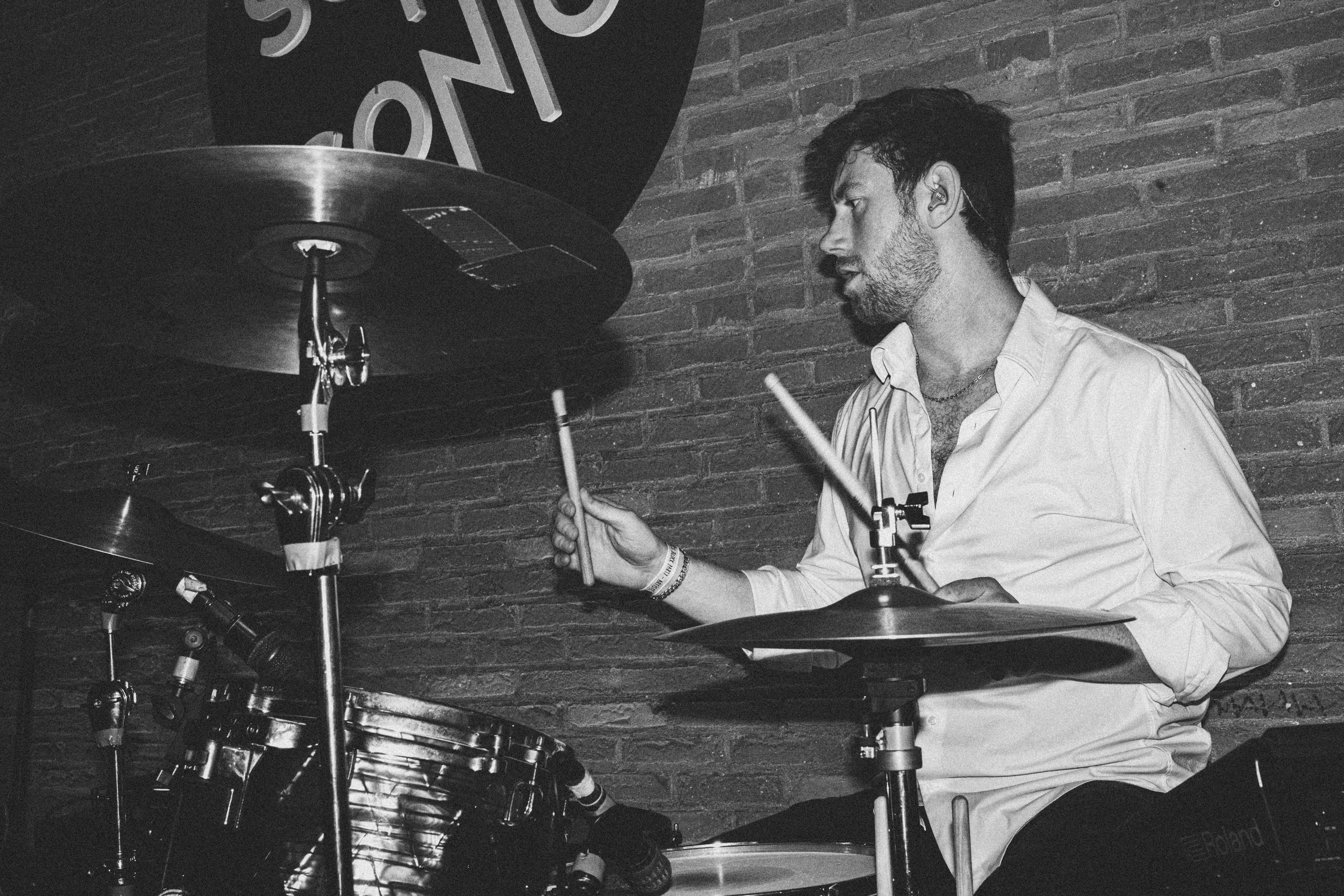 Victor playing drums in high contrast black and white